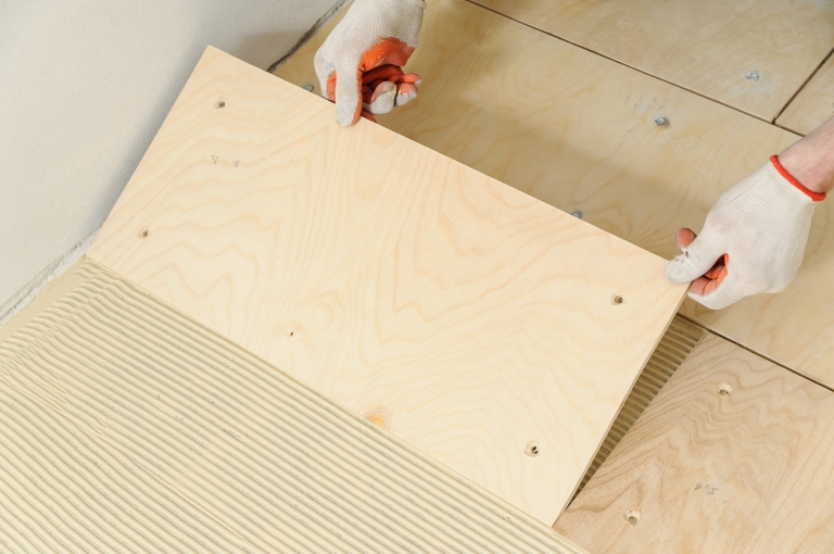 Laying down a wooden plyboard subfloor